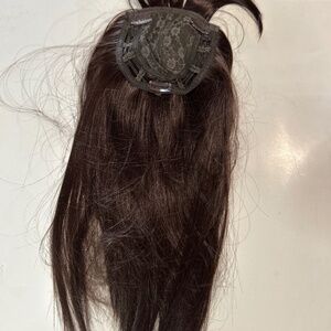 A dark brown hair topper